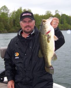 Burnie Haney holds up a largemouth bass while boat fishing. 