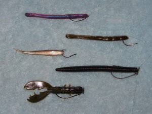 A variety of weedless plastic rigs setup for fishing.