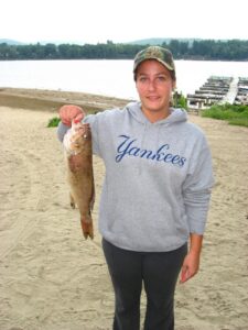 Angler proudly holds up a largemouth bass. 