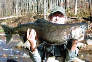 A local angler holds up a salmon caught on the salmon river.