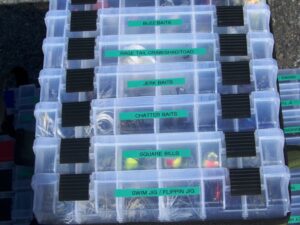 A selection of boxes containing different types of lures designed for freshwater bass fishing.