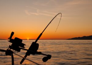 A rod holstered on a boat for trolling, a popular summer method on Oneida Lake.