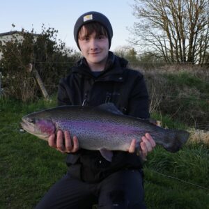 An angler showcases a large steelhead. 