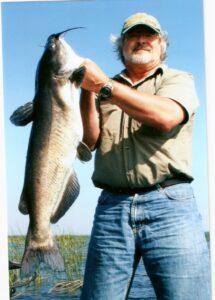 Angler holds up a large catfish. 