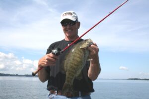 A smallmouth bass caught while using a baitcaster from a boat. 