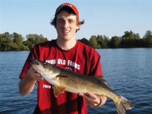 A walleye held out by a happy angler. 