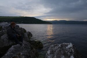 A lure fisherman prepares to fish in the dark for striper bass. 