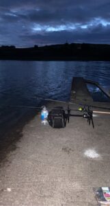 Two bait rods setup at night fishing a calm lake. 