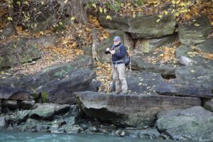A fisherman targets fish from the shore. 